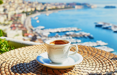 Cup of fresh espresso coffee in a cafe with view on Vesuvius mount in Naples, Campania, Southern Italy